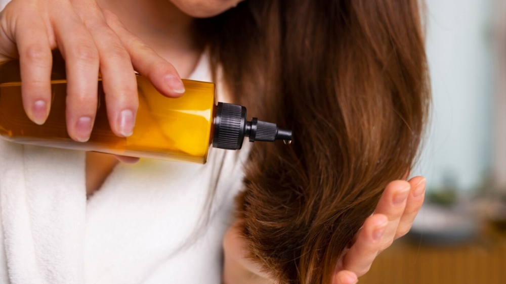 Dùng dầu dưỡng, dầu xả chứa vitamin E giúp mái tóc trở nên bồng bềnh, óng mượt trong mùa Đông